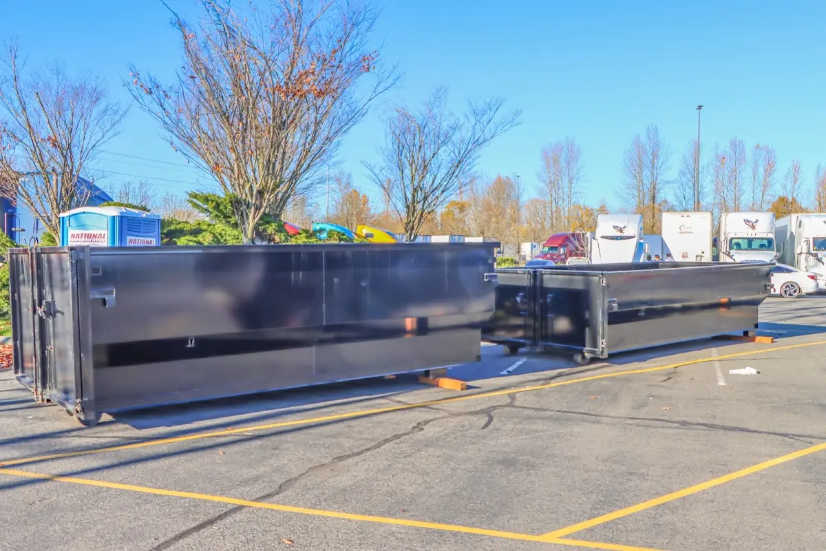 Professional dumpster rental service with roll-off container on residential driveway in Doney Park
